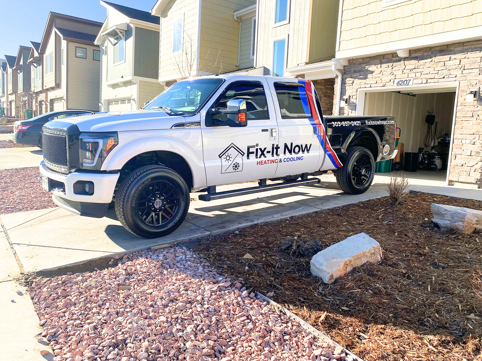 fix-it now work truck in driveway