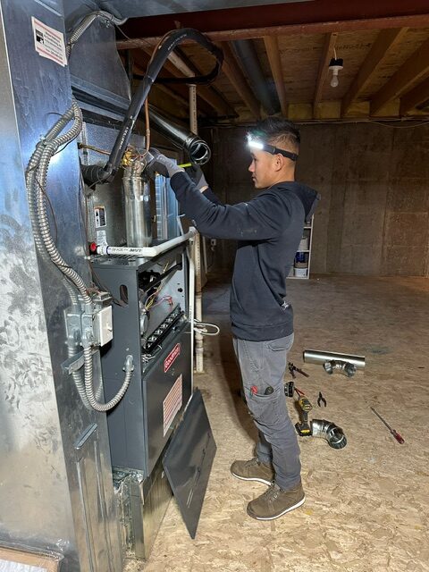 HVAC technician working on a furnace