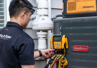 hvac technician working on ac unit outside home