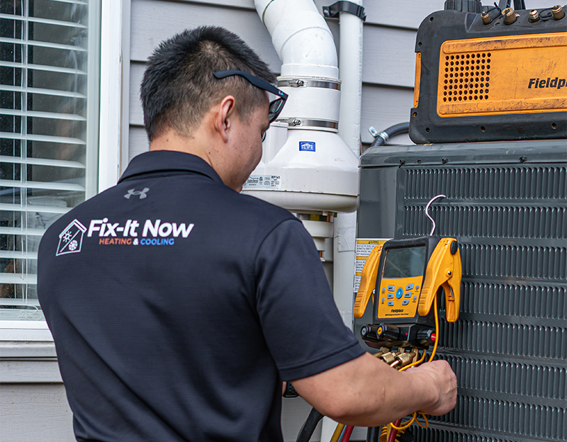 hvac technician workong on outside ac unit